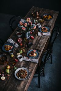 Love the moody colours with the bright pops of colours from the food and flowers