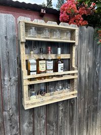 This beautiful reclaimed wood alcohol rack is a must have in your bar or kitchen area. All of our alcohol shelves are made with premium pallet wood that has been recycled to created a rustic piece that would be a warm addition to any bar or kitchen. All of our pieces are made-to-order and can be customized to fit your needs. The shelf provides ample space to organize and display your bottles, allowing you to proudly exhibit your collection. The inside of the shelf can hold four bottles and glasses can rest on top of the shelf. Per request, a shelf can be made inside the rack for additional glasses. Dimensions: 29" Tall 22-3/4" wide 4-1/4" deep