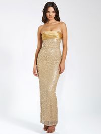 Introducing our show-stopping Lainey strapless maxi dress, your new go-to for the holiday season! The incredible gold color is sure to turn heads as you enter the room. With a bodycon fit and cups inserted at the bust for comfort and support, this dress also features a small slit at the back for easy mobility. Fully lined and made of a gorgeous sequin beaded fabric adorned with multi-sized gold pearls and luxe gold double duchess satin, it exudes elegance and glamour. Perfect for a range of occa