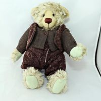 This bear was for sale recently - from Japan but the clothes are Zwergnase I'm not so sure of the bear. More research to be made on Sue the person who signed the foot