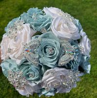 Handmade Quinceañera Bouquet/ Wedding.  With Light Sage Green and Ivory Roses. Finished off with Silver brooches and Butterflies.  *Please note brooches can change in style due to availability.* Decor / color combinations can be changed upon request. {This is a made to order Bouquet}