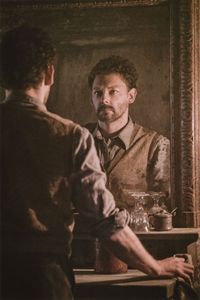 Aberforth Dumbledore [Richard Coyle] looking into the two-way mirror in the Hogs Head Inn