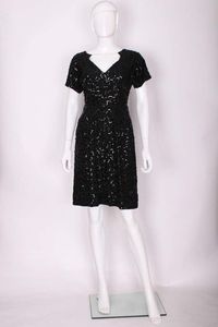 For Sale on 1stDibs - A chic cocktail dress by French designer Jeanne Paquin. The dress is made of a wool crepe with black sequins sewn on in a squiggle pattern . It has a v