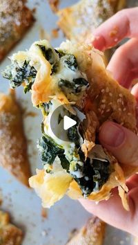 Carolina Gelen on Instagram: "Follow @carolinagelen for more SPANAKOPITA TRIANGLES - flaky, crunchy and so so cheesy. This recipe is a mashup between a spanakopita and bourekas, all you need for these hand pies are store bought phyllo pastry, spinach, feta and some other grated cheese of choice. Feta is great on its own, but I like the additional creaminess mozzarella brings Fold the cheesy phyllo, bake it and there you have it! Ingredients (makes 20-24) 10 oz or 350 g low moisture mozzarella, grated 6 oz feta cheese 2 lb frozen spinach, thawed and drained Salt to taste 100 g phyllo pastry, plus more as needed 1 egg, can be substituted with oil or butter Sesame seeds and flaky salt Oil or butter, for brushing Instructions 1. Heat the oven at 400°F or 205°C. 3. Combine the chee