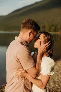 Lake McDonald Engagement Shoot Ideas in GNP | Couples Pose Ideas | Montana Photographer. Not just a photoshoot, it's an adventure, a shared experience in the heart of Glacier National Park at Lake McDonald! Find engagement photos at lake, engagement photos by lake, lake engagement ideas and june lake engagement photos. Book Brogan for an adventure engagement session at photographybybrogan.com.