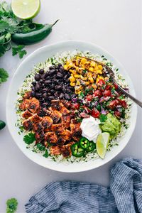 Chicken Burrito Bowls combine perfectly seasoned chicken, cilantro-lime rice, and your favorite toppings for a delicious meal.