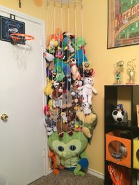 9 years of stuffed animals finally off the floor! Perfect use for an unused corner in a kid's bedroom - Stuffed animal jail storage from floor to ceiling