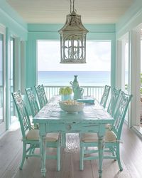 A coastal dining room with light, airy colors, natural materials, and ocean-inspired decor. The design creates a relaxed and inviting atmosphere, perfect for enjoying meals with a seaside vibe. #CoastalDiningRoom #BeachyVibes #DiningInspo