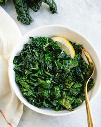 Sauteed kale is the best way to eat this healthy leafy green! Scented with garlic and cooked in olive oil until tender, you'll want to eat it every day. #kale #sauteed #sauteedkale #easykalerecipe #kalerecipe #Howtoeatkale