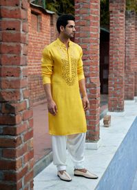 Editor's Note Complete your festive look with our mustard yellow mirror work kurta, specially designed for men and perfect for haldi, mehndi, or sangeet occasions. The vibrant color and intricate mirror work detailing make it a captivating choice. Paired with an off-white salwar and matching mustard yellow stole, this ensemble exudes elegance and style. Get ready to make a lasting impression at your next celebration with this stunning outfit. Fabric: Linen cotton silk Color: Yellow Components: K