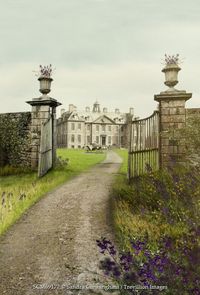 Sandra Cunningham Old gates with flowers and english country house in background