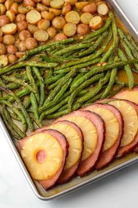 If you're planning a small holiday dinner for Easter, you are going to love this easy sheet pan pineapple ham and veggies. The ham and pineapple are glazed in a sweet and tangy sauce, and all of it cooks together on a sheet pan. It's easy to make and clean-up!