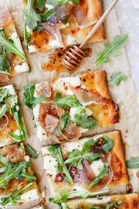 Prosciutto Ricotta Pizza is a sweet and salty white homemade pizza packed with flavor! It takes 25 minutes to make and features a golden crust topped with mozzarella, ricotta, prosciutto, arugula, and a drizzle of hot honey.