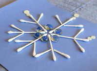 Winter STEM- Build A Snowflake Tinker Tray.  Use loose parts to build snowflakes.  Explore radial symmetry as you incorporate math, science, fine motor work, and creativity in this activity for preschoolers, kindergartners, and elementary kids.