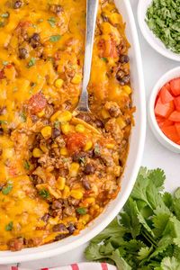 Mexican Ground Beef Casserole is a hearty dish loaded with ground beef, diced tomatoes, black beans, corn, cheddar cheese and corn tortillas.