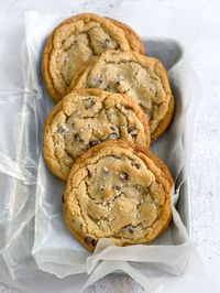 4 small batch chocolate chip cookies in a small tray.