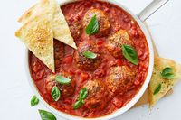 Simmering in a spicy tomato sauce, these supreme pizza rissoles will be one of your new favourite dinners.