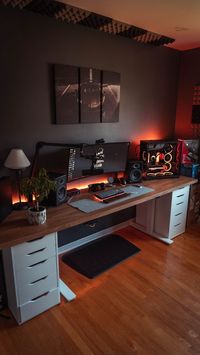 large standing desk with side drawers, wall decor, and gaming set up