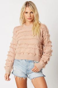 Snuggling up in the Hailey Blush Fringe Sweater will make your day! Soft knit, with alternate stripes of fringe, shapes this cozy sweater with a round crew neckline, long sleeves with drop shoulders, and a slightly cropped bodice. Matching ribbed knit trims the neckline, cuffs, and hem.