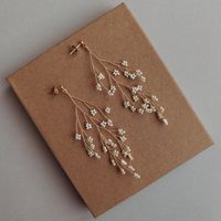 These delicate gold ecru color bridal earrings are really beautifull, delicate, handmade and one of a kind. This unusual jewelry is perfect for rustic, boho, romantic, classic and bohemian Bride. Those delicate accessories will look beautiful with company of romantic wedding updo, messy bun, messy braid or wedding loose updo made of boho waves <3 It is a beautiful alternative to classic wedding earrings. The twig in earrings can be bent freely. Those beautifull earrings will match other wedding accessories in my store [like those hairpiece or hairpin on photos], so please feel free to look around the store :) ] Earrings length: ~8.5 cm Hair accessories are sold separately. The actual appearance, in particular the color of the accessory may differ from the one presented in the pictures This