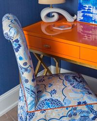 A favorite combination - orange and blue Chinoiserie, note the lovely detail of the orange cording on the chair.