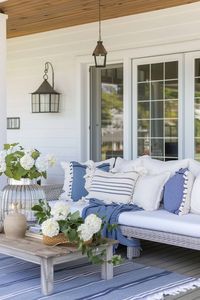 Discover 12 creative coastal front porch ideas to transform your outdoor space into a serene summer retreat, featuring porch swings, hammocks, nautical touches, and more! Add a coastal vibe to your front porch even if you're home isn't directly on the coast. Transform Your Porch: 12 Coastal Design Tips for a Summer Oasis -Casually Coastal.