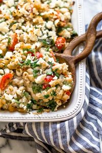 Greek Mac and Cheese, a healthy twist on a comfort food classic made in a creamy cheese sauce with whole wheat pasta, tomatoes, spinach, olives and Feta cheese.