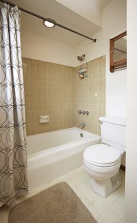 BEFORE: A bland color palette contributed to the dated, lifeless feel of the original bathroom. See how a new, serene color palette entirely changed the look and feel of this space.