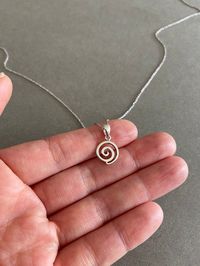 Silver Tiny Mini Swirl Necklace - Sterling Silver Color : Silver Material : Sterling Silver Swirl Size : 10mm Chain Length : 16 inches / 18 inches / 20 inches * Metal components are Sterling Silver. * Suitable for delicate and sensitive skin. * Comes in a jewelry box. If you need extra boxes for gifting....just let us know!