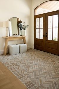 Foyer with wood doors & brick tile