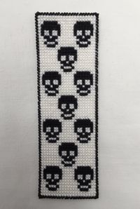 Plastic canvas bookmark with black skull pattern by JollyGoodSew