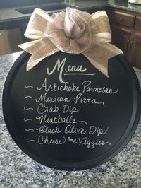 Chalkboard sign- Dollar Store pizza pan sprayed with chalkboard paint and a burlap ribbon hot-glued on. Stand it up on a plate stand. Easy, cheap, and reusable!!!