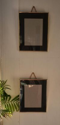 Set of two vintage brass picture frames. These frames have a brass edge,glass front and a forest green mount. They measure 26cm x 20cm edge to edge. The mount is 4cm wide and the gap inside the mount is 12.5cm x 17cm. They have a rope in the back for hanging.