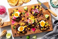 These easy vegetarian and gluten-free tostadas combine earthy black beans and seared yellow squash with pickled red onion and watermelon radish.