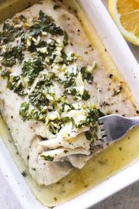 The Best Baked Corvina Recipe | Baked corvina is an elegant seafood dish that's easy to make in only 20 minutes. The tender and flaky fish is coated with a delicious garlic, lemon, and herb melted butter, then briefly roasted for a restaurant-quality meal right at home. - The Top Meal