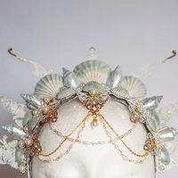 Janina Gold | Costume Design on Instagram: "My first mermaid-themed crown has received such positive feedback, and I'm over the moon! 🧜‍♀️✨  It was sold in no time, and even the reel blew up by my standards. Thank you so much for your support!   I'm excited to create more like this in the future. Which colors would you love to see next? Comment below! 👇🎨  #JaninaGoldArt #MermaidCrown #MermaidCore #FantasyFashion #ShellCrown #HeadpieceDesign"