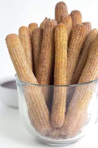 Baked Churros - These baked churros are just as good as any fried churro! It has a crunchy exterior that's been rolled in cinnamon and sugar and a tender inside. They're highly addicting and fun to dip!