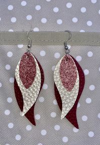 Faux leather dangle earrings.  Colors: Matte Maroon, Pearl Cream, Light pink Glitter Approx 3 1/4" length.  Nickel free & lead free metal alloy.