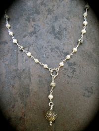 "PLEASE PAY ATTENTION TO PRODUCTION AND SHIPPING TIMES AS THEY MAY BE LONGER THAN OTHER SELLERS....THANK YOU! This one is a personal favorite! High quality, lustrous white pearls. Wire wrapped links form the chain of this necklace. It is a unique, Rosary style with an ornate silver pendant that kind of resembles a Christmas ornament! It is 19 inches in length, has a lobster claw clasp and has a 3\" extender chain. This is a classic \"Y\" necklace! Comes gift boxed with ribbon; a lovely gift for