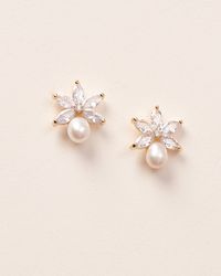 Perfectly floral with a dainty pearl accent, our Naomi Freshwater Pearl Studs are perfect for brides & bridesmaids. Cubic zirconias & freshwater pearls Measures 0.75" in length Hypoallergenic, lead-free & nickel-free. Style #4153