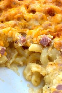 Casserole dish of oven baked mac and cheese with ham