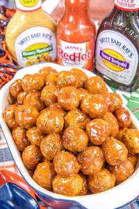 Awesome Sauce Party Meatballs – these easy party meatballs are AWESOME! They are always the first thing to go at our parties. Frozen meatballs, honey mustard dressing, teriyaki sauce, and hot sauce. Ready to eat in under 30 minutes. Can also slow cook in the crockpot. Great for tailgating, potlucks, and holiday parties! Equally delicious as a main dish.