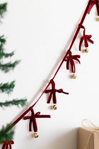 Decorate your tree, staircase, or fireplace in traditional Christmas style with the "Velvet Bell Ribbon Chain" from the Beige & Stone Christmas collection. Each with ten red bows and gold bells.Dimensions:Total: H 4" x L 55" Gold bells: Diameter 0.78"Made of Velvet ribbon and iron bells Each chain consists of 10 bows and bells