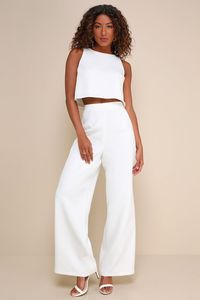 Sophisticated and flirty, the Lulus Timeless Disposition White Wide-Leg Two-Piece Jumpsuit will never go out of style! This impressive two-piece jumpsuit has a crepe woven fabrication that shapes a crop top with a crew neckline and a darted bodice with a top button closure and a keyhole-style cutout at the back. The matching pants have a high-waisted fit, darted details, and wide pant legs that fall to ankle-length hems. Pants have a hidden zipper/clasp at back. Fit: This garment fits true to si