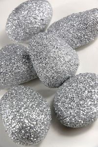 Paint rocks with glue and sprinkle with whatever color glitter and fill a vase