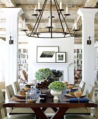 Exposed beams, white bookshelves, flowers, dark wood table. #diningroom