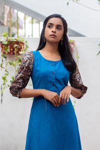 Rs.2200
Puffed Kalamkari sleeves with a solid blue dress. Front open buttons supports feeding. 

The model in the picture is wearing size S and length of the dress is 46 inches.