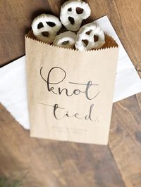 "Knot Tied. These modern and simple snack bags add a punch of fun to your snack buffet. Use these bags to let your guests take a pretzel to go after a fun filled night at your reception or snack on as they party ▲ Your bags will be printed just as shown (including your info). Any other design changes require this artwork add-on - https://etsy.me/34R1oMZ ▲ Easy Ordering Choose a digital proof, printable file, 1 mailed sample, or sets of 25 printed favor bags mailed to your doorstep We offer two s