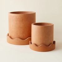 Featuring playful squiggles, the Rosemead Pot is made from cement with a terracotta hue and is perfect for both indoor and outdoor use. The saucer has a unique squiggle-edged rim and the pot has a drainage hole.  Dimensions: Small: 12" x 10.75" Large: 16.25" x 15"