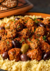 Moroccan meatballs are made with ground meat, onions, and herbs, and served with a flavorful tomato sauce. Pair with olives and couscous!